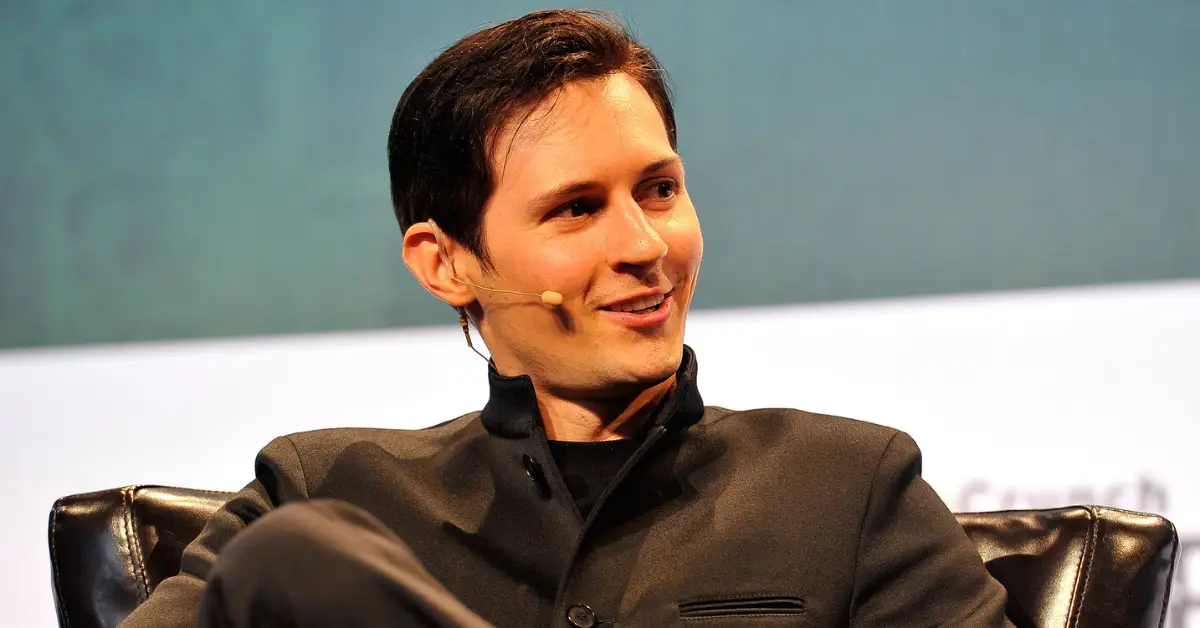 The founder of Telegram speaking on stage with a headset microphone during a tech event, discussing digital freedom and innovation.