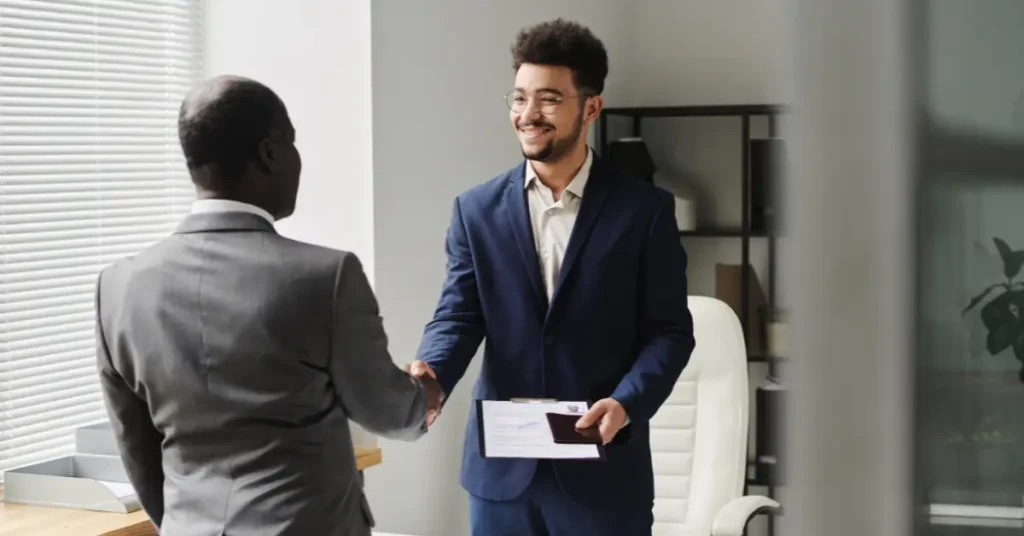 Business professionals shaking hands, symbolizing trusted UAE business setup and Golden Visa assistance.