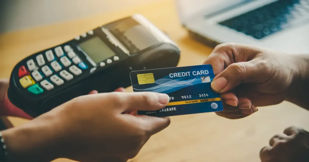 Close-up of hands using a credit card at a payment terminal, symbolizing banking security in the UAE
