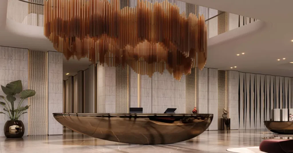 Prestigious commercial lobby at The Symphony featuring a sculptural reception desk and dramatic suspended chandelier centerpiece.