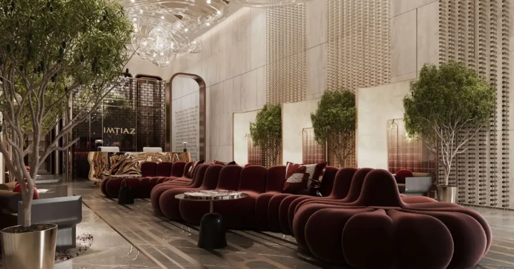 Architectural interior of The Symphony’s lobby with designer seating, elegant light installations, curated textures, and lush indoor greenery.