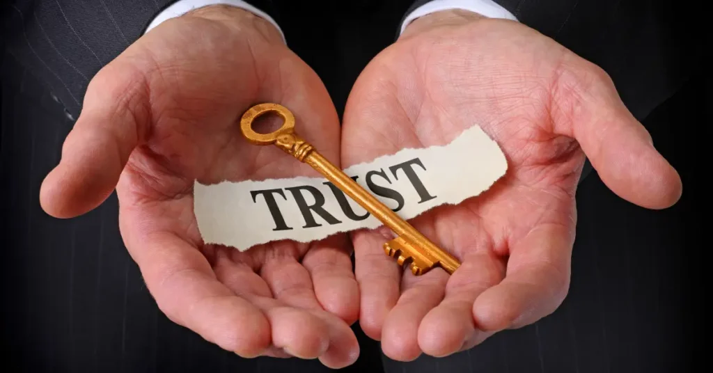 Hands holding a golden key with the word “Trust,” symbolizing GenZone’s transparent and reliable Dubai relocation and company setup services.
