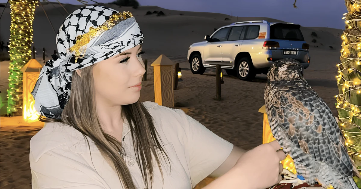 Maria Enjoying with a falcon during a desert experience in Dubai, showcasing Emirati culture and wildlife interaction.