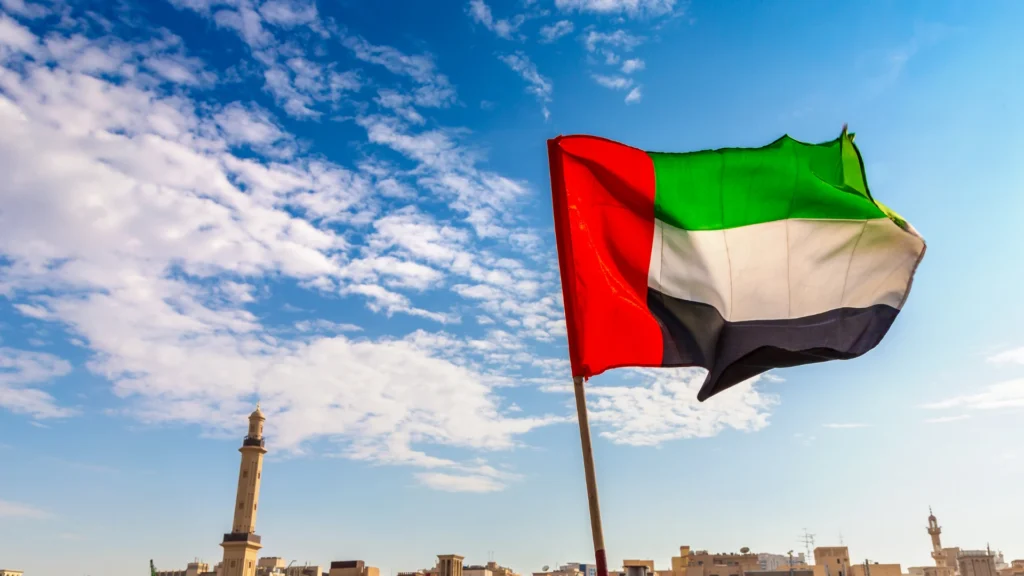UAE flag overlooking Dubai Creek representing residency, company setup and wealth preservation
