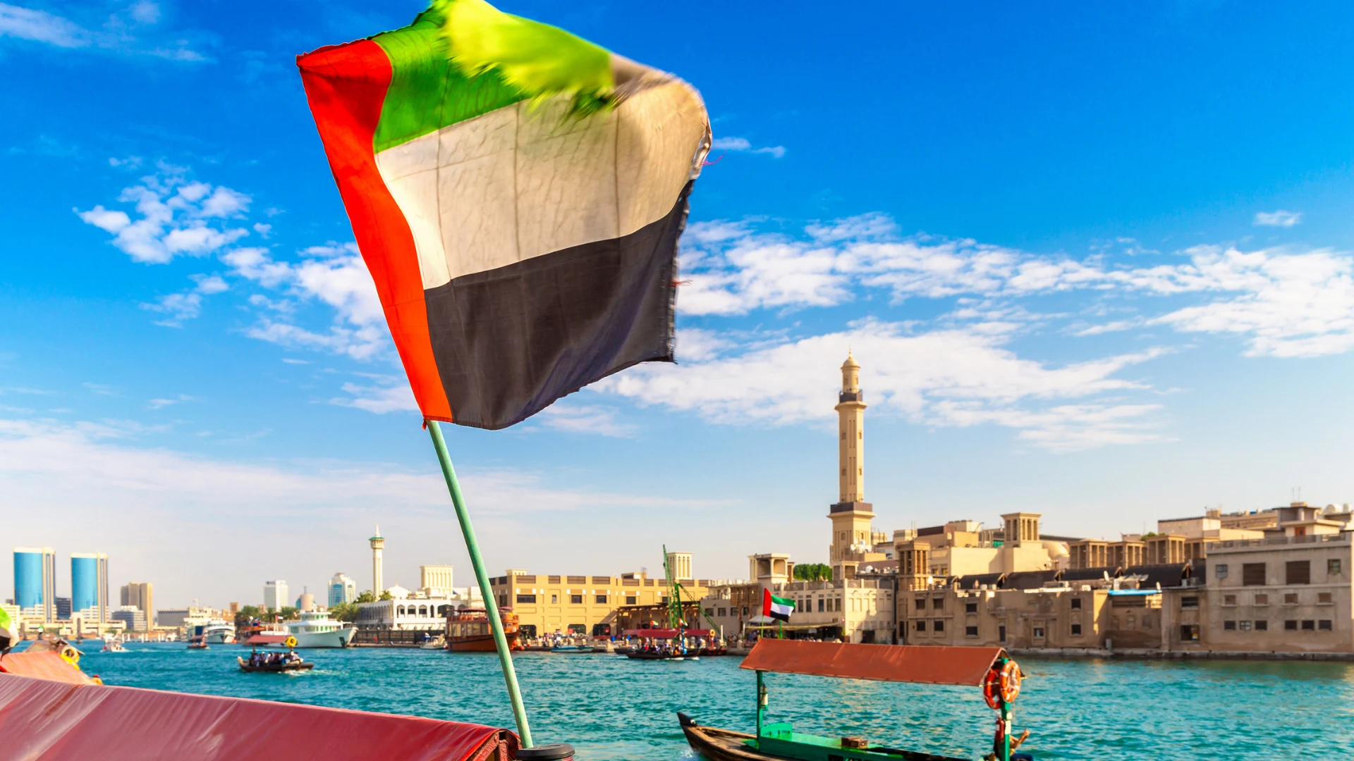 UAE flag against Dubai skyline highlighting business expansion and property investment opportunities
